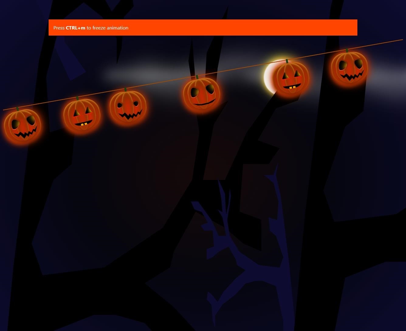 pumpkins dangling over dark background